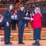 Pupils shaking hands and collecting the trophy for winning the Barnardo's Choral Competiton thumbnail