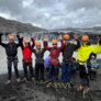 Pupils in climbing harnesses and helmets enjoying exploring glaciers on their Geography Trip to Iceland thumbnail