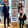 Kelly and Matthew proudly showing their art and photography pieces to be displayed in a local gallery thumbnail