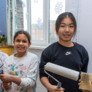 Prep School pupils holding paint brushes to paint a room as part of Make A Difference Day thumbnail