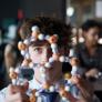 A-Level pupil examining a model of a molecular structure in a Chemistry lesson thumbnail