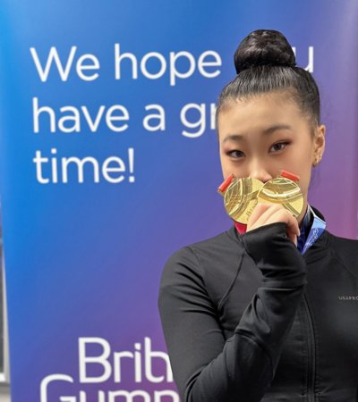 Dinburgh holding two gold medals at the British Open Gymnastics competition