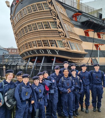 Lower Fifth pupils in the Navy standing in front of the HMS Victory on a CCF trip to Portsmouth