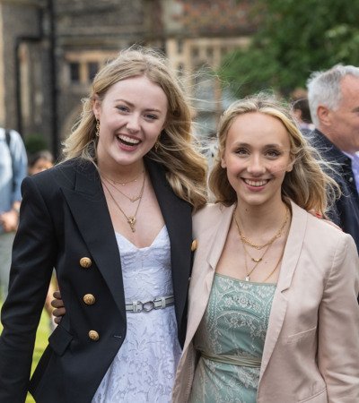 Pupils with their arms round each other celebrating their Graduation in the Quad