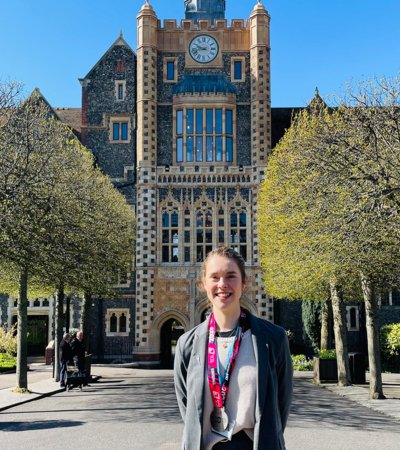 Olivia Haverson standing in the Quad with her Brighton Marathon medal