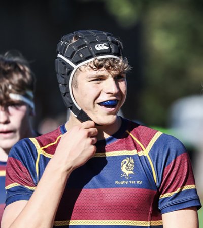 1st XV Rugby player on the pitch wearing a scrum cap