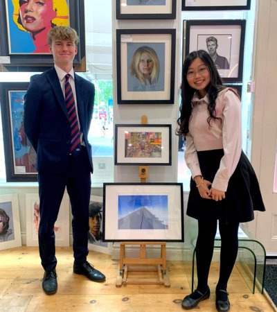 Kelly and Matthew proudly showing their art and photography pieces to be displayed in a local gallery