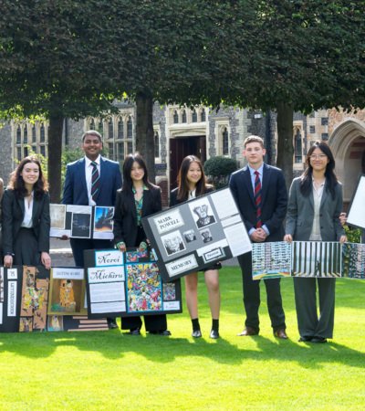 GCSE and A-Level Art and Photography pupils in the Quad holding their coursework pieces