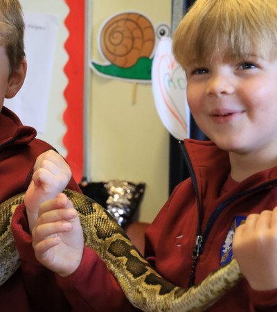 Pre-Prep pupils excitedly holding a snake at Reptylers