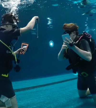 Pupils in the pool with scuba equipment conducting experiments in Scuba Physics