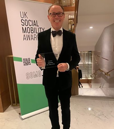 Richard Cairns holding his award at the the UK Social Mobility Awards