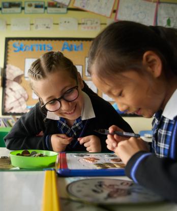 Pre-Prep pupils enjoying learning about money in the classroom using coins