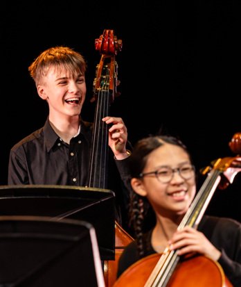 Music pupils enjoying performing a piece on the cello and double bass