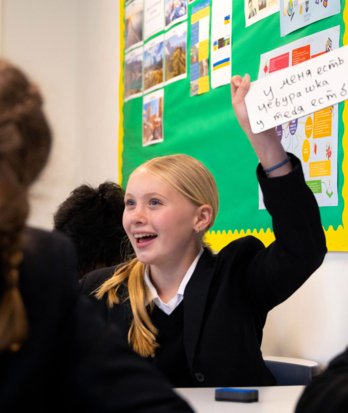 Pupil practicing their writing on a whiteboard in a Russian lesson