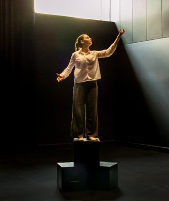 Drama pupil standing on a block and performing a piece in their Drama lesson