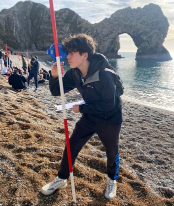 Pupil with Clinometer and Ranging Stick on a Geography Field Trip