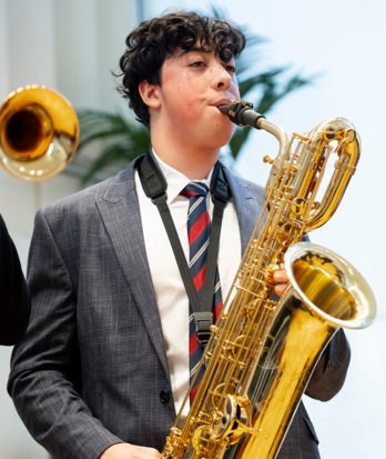 Sixth Form pupil playing the saxophone with Swing Band in a concert