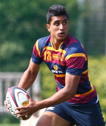 Pupil running with the rugby ball in a fixture