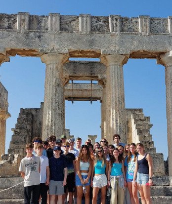 Pupils standing in front of the Acropolis on a Classics Trip to Athens