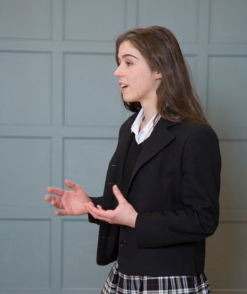 Pupil in a Debating Club session lesson giving a speech to the rest of the group