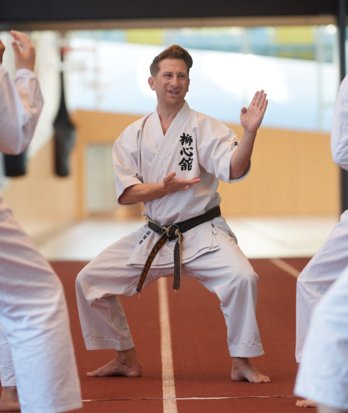 Karate instructor in Karate Gi and a black belt instructing a session on the track in the SSS