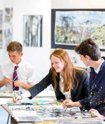 GCSE Art pupils in the Art Room enjoying talking whilst working on their coursework pieces