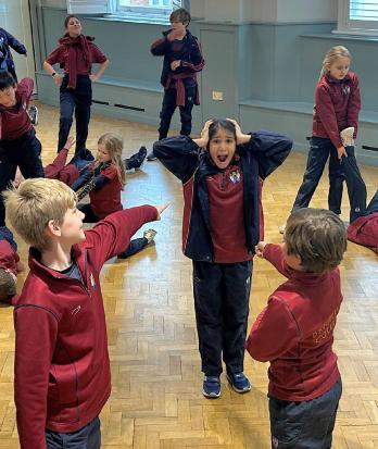 Prep School pupils acting out scenes in Improv Society in the Hall