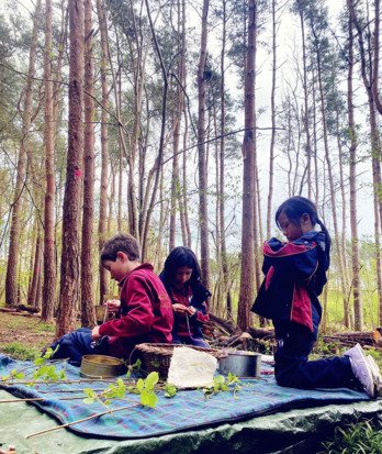 Pre-Prep pupils in Wood and Wild club crafting in the woods