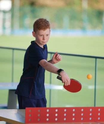 Pupil playing table tennis on the Home Ground in games kit