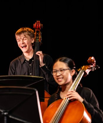 Music pupils enjoying performing a piece on the cello and double bass