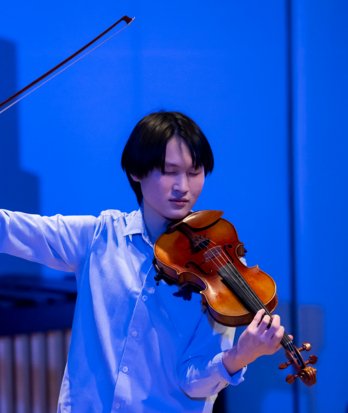 Pupil performing in a concert on the violin