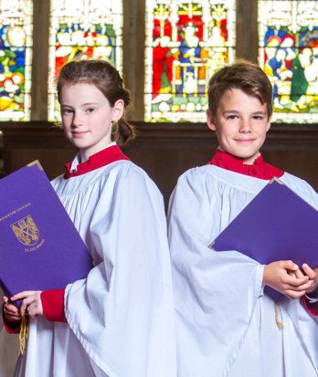 Choristers in their robes holding their music in the Chapel