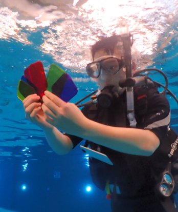 Pupils in the pool with scuba equipment conducting experiments in Scuba Physics