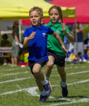 Pre-Prep pupils running in a race on Sports Day in their House tops