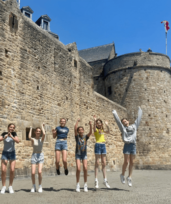 Prep School pupils jumping for joy on a French trip to Normandy