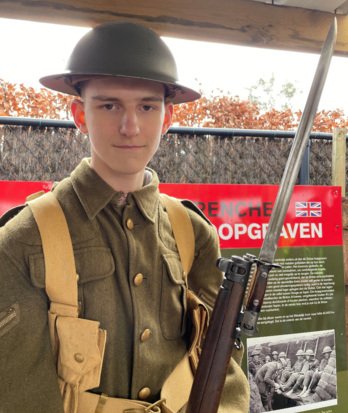 4th Form pupil dressed in Army uniform and holding a gun on a trip to Ypres