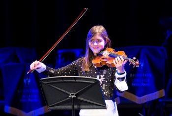  Pupil in a Christmas jumper performing a violin piece in the annual Christmas Concert 