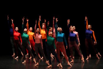  Sixth Form dancers on the stage in different coloured outfits 