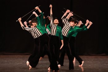  Dancers on stage performing a group piece with canes and bowler hats 