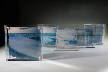  Images of the waves hitting the shore and the stones contained inside glass blocks 