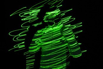  Silhouette of a person with green lines done through using long exposure photography 