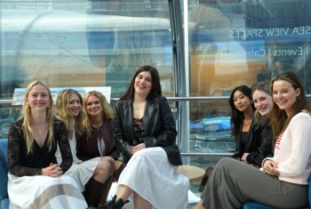  Pupils happily sitting together in the i360 on Brighton Seafront 