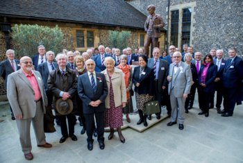  Old Brightonians on a tour of the school gathered outside around the Memorial Statue 