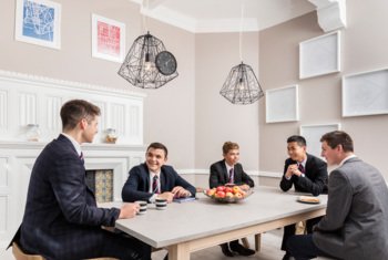  Boarders with cups of tea enjoying chatting in their break time in the Common Room 