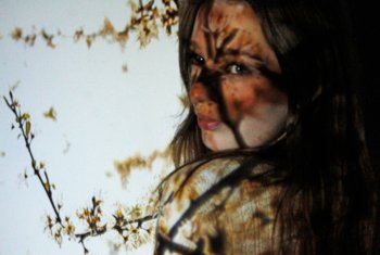  Photography coursework piece of a girl with shadows of flowery branches across her face 