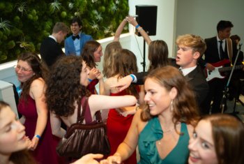  Lower Sixth pupils in black tie dancing together at the UNICEF ball 