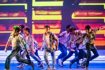  Dancers performing a group piece on stage at the Dance Show 