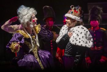  Prep School pupils performing a play on stage dressed as the King and Queen 