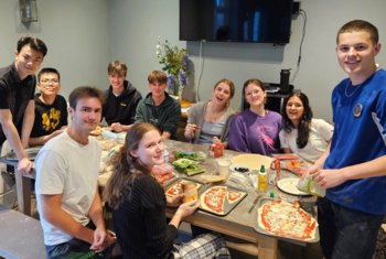  Boarding pupils enjoying making homemade pizzas together 