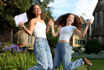  Upper Sixth pupils jumping for joy with their results on Results Day 